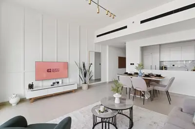 a living room with a couch and a dining room at GuestReady - Modern retreat in JVC in Dubai