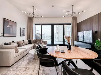 a living room with a couch and a table at Skyline Oasis - Business Bay with Burj Khalifa Vie in Dubai