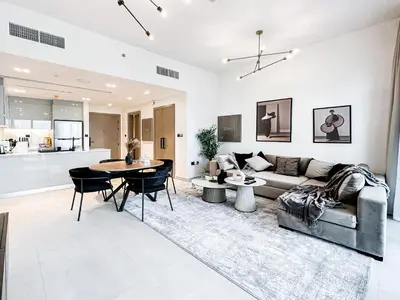 a living room with a couch and a table at Skyline Oasis - Business Bay with Burj Khalifa Vie in Dubai