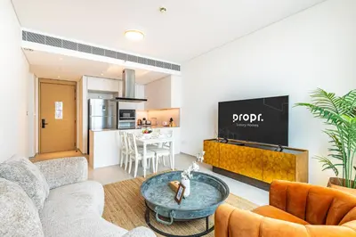 a living room with a couch and a table at High-Floor Luxury 2BR, Sea View, Address JBR in Dubai
