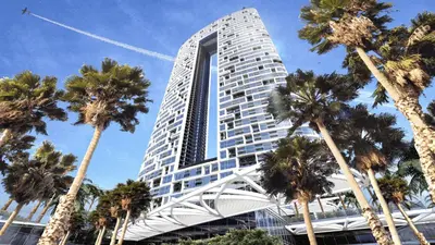 a tall building with palm trees in front of it at High-Floor Luxury 2BR, Sea View, Address JBR in Dubai