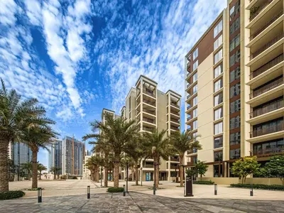 a view of a city with palm trees and buildings at Modern one bedroom apartment in lotus creek beach in Dubai