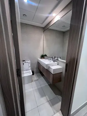 a bathroom with two sinks and a toilet at Azizi riviera in Dubai