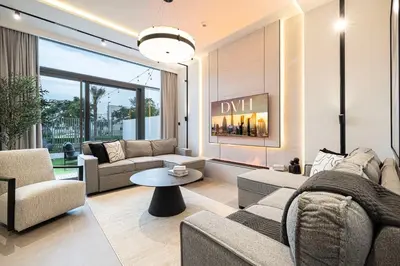 a living room with couches and a fireplace at Luxury 4BR Villa, Bali Pool Retreat, Ruba A Ranches 3 in Dubai