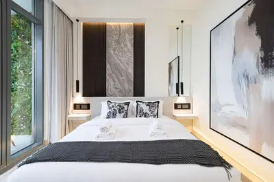 a bedroom with a large white bed and a large window at Luxury 4BR Villa, Bali Pool Retreat, Ruba A Ranches 3 in Dubai