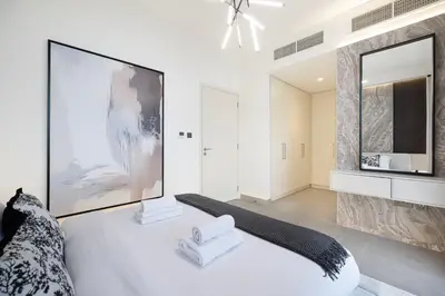 a large white room with a bed and a tv at Luxury 4BR Villa, Bali Pool Retreat, Ruba A Ranches 3 in Dubai
