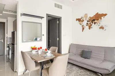 a living room with a table and a couch at FIRST CLASS Studio Cozy Luxe Sanctuary in Dubai
