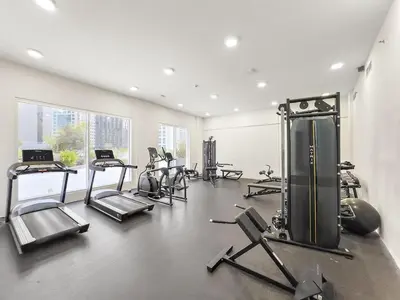 a gym with several treadmills and exercise bikes at FIRST CLASS Studio Cozy Luxe Sanctuary in Dubai