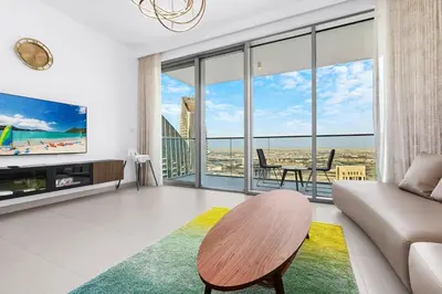 a living room with a couch and a table at Spacious Dubai Apartment with Water Views and Luxury Amenities in Dubai