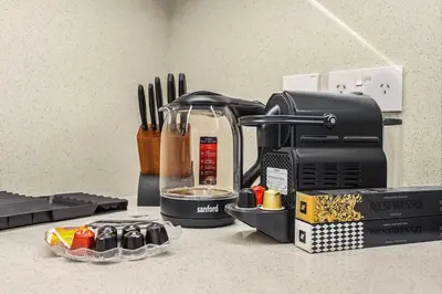 a kitchen counter with a coffee maker and utensils at Spacious Dubai Apartment with Water Views and Luxury Amenities in Dubai