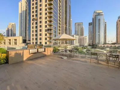 a large patio with tables and chairs in a city at Spacious Dubai Apartment with Water Views and Luxury Amenities in Dubai