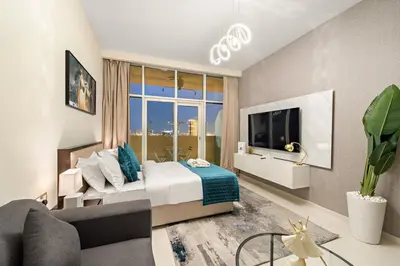 a bedroom with a bed and a large window at FIRST CLASS Studio Luxe Cozy Living in Dubai