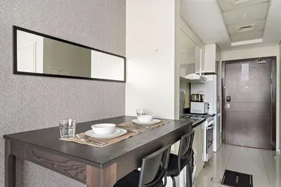 a kitchen with a table with two bowls on it at FIRST CLASS Studio Luxe Cozy Living in Dubai