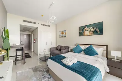 a bedroom with a bed and a couch in it at FIRST CLASS Studio Luxe Cozy Living in Dubai