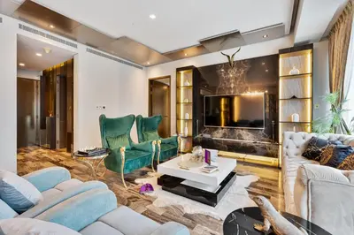 a living room with couches and a tv at Highend 2BR Palm Sea View with Pool and Nightlife Marina in Dubai