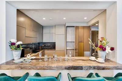 a dining room with a table in a kitchen at Highend 2BR Palm Sea View with Pool and Nightlife Marina in Dubai