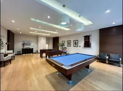 a large room with a pool table in it at Highend 2BR Palm Sea View with Pool and Nightlife Marina in Dubai