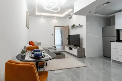 a living room with a table and a kitchen at Dubai Marina - 1 BHK Stunning Apartment in Dubai