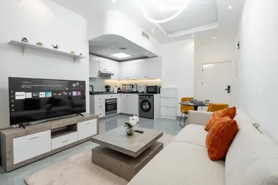 a living room with a couch and a large tv at Dubai Marina - 1 BHK Stunning Apartment in Dubai
