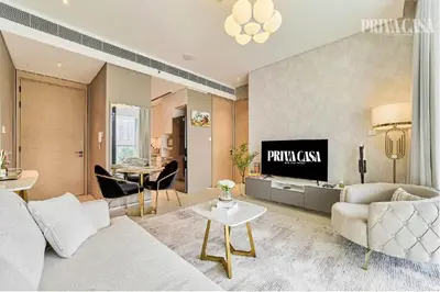 a living room with a couch and a tv at PRIVACASA - The Address Beach Resort residences in Dubai