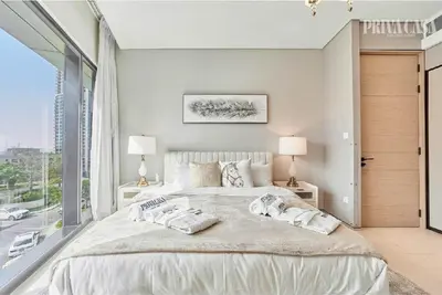 a bedroom with a large bed with a large window at PRIVACASA - The Address Beach Resort residences in Dubai