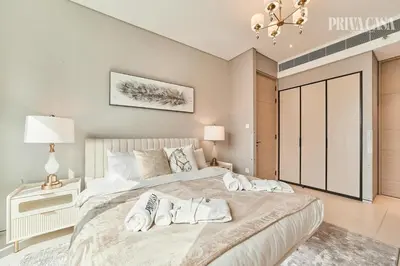 a bedroom with a large bed with two towels on it at PRIVACASA - The Address Beach Resort residences in Dubai
