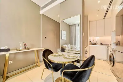 a kitchen and dining room with a table and chairs at PRIVACASA - The Address Beach Resort residences in Dubai