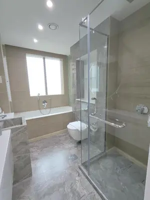 a bathroom with a glass shower and a toilet at Marina Bliss Luxe Stay with Waterfront and Palm Views in Dubai