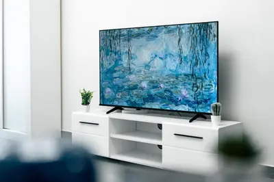 a flat screen tv sitting on a white entertainment center at Dubai Marina - Lovely Studio Apartment in Dubai