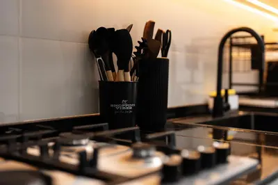 a container of kitchen utensils on a kitchen counter at Dubai Marina - Lovely Studio Apartment in Dubai