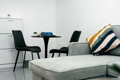 a living room with a couch and chairs and a table at Dubai Marina - Lovely Studio Apartment in Dubai