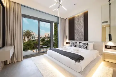 a bedroom with a large bed and a large window at Elegant 4BR Villa, Bali Pool Retreat, Ruba, A Ranches 3 in Dubai