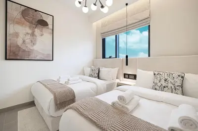 a living room with two beds and a couch at Elegant 4BR Villa, Bali Pool Retreat, Ruba, A Ranches 3 in Dubai