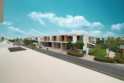 a view of a building from the street at Elegant 4BR Villa, Bali Pool Retreat, Ruba, A Ranches 3 in Dubai
