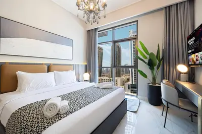 a hotel room with a bed and a large window at 2BR Dubai Gem steps from Dubai Mall & Burj in Dubai