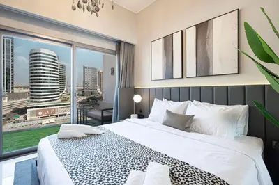 a bedroom with a large bed and a large window at 2BR Dubai Gem steps from Dubai Mall & Burj in Dubai