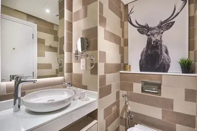 a bathroom with a sink and a deer head on the wall at The Seven Palm with free rooftop pool & beach in Dubai