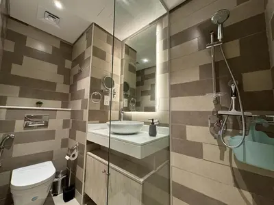 a bathroom with a toilet and a sink and a shower at The Seven Palm with free rooftop pool & beach in Dubai