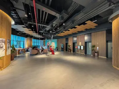 an empty lobby of a building with tables and chairs at The Seven Palm with free rooftop pool & beach in Dubai