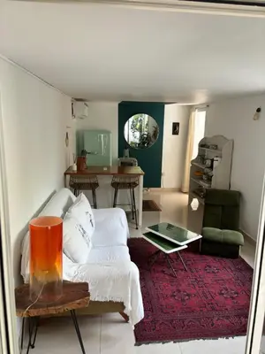 a living room with a couch and a table at Private Cottage with bbq area 5 min walk to beach! in Dubai