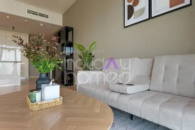 a living room with a couch and a coffee table at Spacious and Elegant 2BR Marina Gate 2 in Dubai