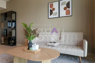 a living room with a couch and a coffee table at Spacious and Elegant 2BR Marina Gate 2 in Dubai