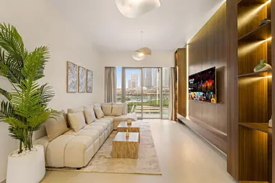 a living room with a couch and a table at Panoramic 2BR with Pool & Burj View Next to Mall in Dubai