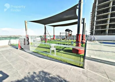 a tent on the roof of a building with a playground at Bloomfields Stylish 1br Orchid Residence in Dubai