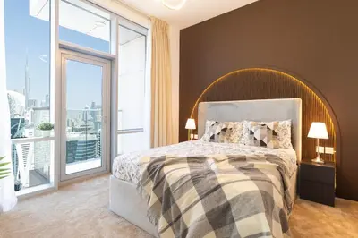 a bedroom with a large bed and a large window at 4BHK in Business Bay w Burj Khalifa View Noora 4304 in Dubai