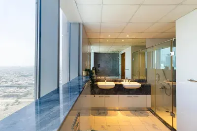 a bathroom with two sinks and a shower at 4BHK in Business Bay w Burj Khalifa View Noora 4304 in Dubai