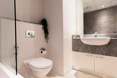 a bathroom with a toilet and a sink at 4BHK in Business Bay w Burj Khalifa View Noora 4304 in Dubai