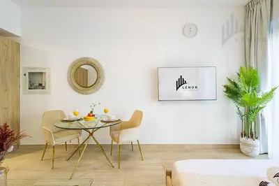 a dining room with a table and chairs at Chic Studio Living JVC in Dubai
