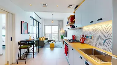 a kitchen and living room with a sink and a table at Cozy and Modern 1BR in Dubai Hills in Dubai