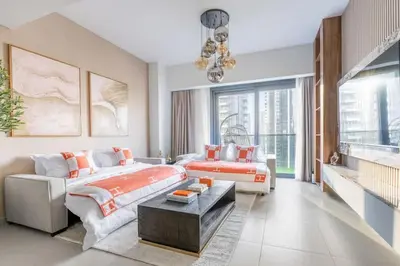 a large bedroom with a bed and a couch at Luxury 4BR with Hermes Touch & Burj Khalifa View in Dubai